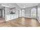 Bright living room featuring wood floors, arched windows and open to the kitchen at 4705 Wild Iris Dr. # 305, Myrtle Beach, SC 29577