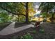 Scenic backyard view with mature trees, lush landscaping, and a charming bench at 509 Heston Point Dr., Pawleys Island, SC 29585