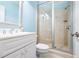 Cozy bathroom with a glass shower, white vanity, and blue walls, offering a serene atmosphere at 509 Heston Point Dr., Pawleys Island, SC 29585