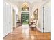 Bright foyer with hardwood floors, chandelier, and a glimpse of the landscaped yard through the front door at 509 Heston Point Dr., Pawleys Island, SC 29585
