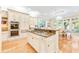Bright kitchen featuring a center island, built-in appliances, white cabinetry, and hardwood floors at 509 Heston Point Dr., Pawleys Island, SC 29585