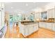 Open-concept kitchen with a center island, granite countertops, and stainless steel appliances, flowing into the dining area at 509 Heston Point Dr., Pawleys Island, SC 29585