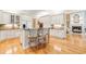 Gourmet kitchen featuring a center island with seating, white cabinetry, and hardwood floors at 509 Heston Point Dr., Pawleys Island, SC 29585