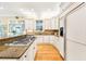 Well-lit kitchen featuring custom cabinetry, stone backsplash, stainless appliances, and an eat-in bar at 509 Heston Point Dr., Pawleys Island, SC 29585