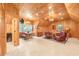 Cozy living room featuring wood paneled walls, multiple seating areas and a dining table at 509 Heston Point Dr., Pawleys Island, SC 29585