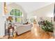 Spacious living room with tall ceilings, large windows, fireplace, hardwood floors, and elegant furnishings at 509 Heston Point Dr., Pawleys Island, SC 29585