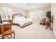 Spacious main bedroom with a large bed, neutral color scheme, plantation shutters, and lots of light at 509 Heston Point Dr., Pawleys Island, SC 29585