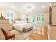 Main bedroom with hardwood floors, a chandelier, neutral colored walls, and plenty of natural light at 509 Heston Point Dr., Pawleys Island, SC 29585