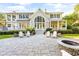 Stunning rear exterior with a spacious patio, fire pit, and lush landscaping at 509 Heston Point Dr., Pawleys Island, SC 29585