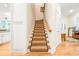 Stairway with hardwood steps and carpet runner, offering access to the upper level of the home at 509 Heston Point Dr., Pawleys Island, SC 29585