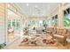 Spacious sunroom featuring lots of natural light, neutral color palette, and multiple seating areas at 509 Heston Point Dr., Pawleys Island, SC 29585