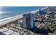 Aerial view of condo building on beach near ocean, offering stunning waterfront access and scenic views at 5523 North Ocean Blvd. # 1903, Myrtle Beach, SC 29577