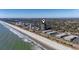 Drone's eye view of condo on beach surrounded by lush green trees, offering stunning waterfront views at 5523 North Ocean Blvd. # 1903, Myrtle Beach, SC 29577