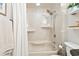 Clean bathroom showcases a shower and tub combination with white tiled walls and coordinating fixtures at 5523 North Ocean Blvd. # 1903, Myrtle Beach, SC 29577