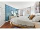 Bright bedroom with patterned accent wall, white furniture, and hardwood floors at 5523 North Ocean Blvd. # 1903, Myrtle Beach, SC 29577