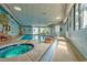 Indoor pool area featuring a jacuzzi, muraled wall, and ample natural light, perfect for year-round enjoyment at 5523 North Ocean Blvd. # 1903, Myrtle Beach, SC 29577