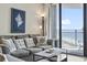 Cozy living room featuring a comfortable sofa, stylish decor, and natural light from balcony access at 5523 North Ocean Blvd. # 1903, Myrtle Beach, SC 29577