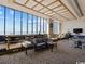 Common lounge area with tables, seating, and a large ocean view window at 5523 North Ocean Blvd. # 1903, Myrtle Beach, SC 29577