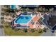 Aerial view of a pool with many lounge chairs and tables surrounded by palm trees at 5523 North Ocean Blvd. # 1903, Myrtle Beach, SC 29577