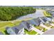 Community aerial view showcases lush landscaping, a pond, and well-maintained homes at 5605 Whitebark Dr., Myrtle Beach, SC 29577