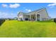 Expansive back yard with covered porch, patio space and black metal fence at 5605 Whitebark Dr., Myrtle Beach, SC 29577