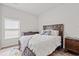 Bright bedroom with a solid wood bed frame, colorful rug, and natural light from a window at 5605 Whitebark Dr., Myrtle Beach, SC 29577