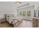 Spacious main bedroom with tray ceiling, wood-look floors, and natural light at 5605 Whitebark Dr., Myrtle Beach, SC 29577