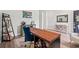 Bright office space with modern desk, comfortable chair, decorative shelves, and stylish sideboard at 5605 Whitebark Dr., Myrtle Beach, SC 29577