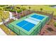 Outdoor pickleball court with new surface, net, and surrounding green landscaping at 5605 Whitebark Dr., Myrtle Beach, SC 29577
