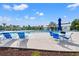Community pool featuring lounge chairs, umbrellas, blue sky, and adjacent clubhouse at 5605 Whitebark Dr., Myrtle Beach, SC 29577