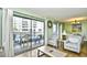 Relaxing balcony view with sliding glass doors, offering an indoor-outdoor living experience with chairs and a table at 5905 South Kings Hwy. # 116B, Myrtle Beach, SC 29575