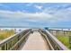 Wooden boardwalk providing easy access to the sandy beach and ocean views at 5905 South Kings Hwy. # 116B, Myrtle Beach, SC 29575