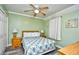 Bright bedroom featuring a queen bed with side tables and lamps, complemented by a ceiling fan at 5905 South Kings Hwy. # 116B, Myrtle Beach, SC 29575