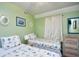 Bright bedroom with two twin beds, seashell themed bedding, and neutral decor at 5905 South Kings Hwy. # 116B, Myrtle Beach, SC 29575