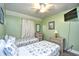 This cheerful bedroom features twin beds, nautical decor, and a ceiling fan for comfortable living at 5905 South Kings Hwy. # 116B, Myrtle Beach, SC 29575
