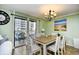 A charming dining room features a square table, seating for six, and access to a private balcony at 5905 South Kings Hwy. # 116B, Myrtle Beach, SC 29575