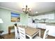 Open-concept kitchen and dining area featuring white cabinetry and modern appliances, ideal for Gathering gatherings at 5905 South Kings Hwy. # 116B, Myrtle Beach, SC 29575
