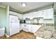 Well-equipped kitchen with white appliances and granite countertops, offering a functional and stylish cooking space at 5905 South Kings Hwy. # 116B, Myrtle Beach, SC 29575