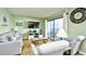 Comfortable living room with sliders to the balcony, featuring light green walls, neutral furniture, and a flat-screen TV at 5905 South Kings Hwy. # 116B, Myrtle Beach, SC 29575