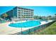 Resort swimming pool with lounge chairs and umbrellas, set against a backdrop of multi-story condo buildings at 5905 South Kings Hwy. # 116B, Myrtle Beach, SC 29575