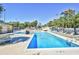 Large outdoor swimming pool with lounge chairs, surrounded by lush greenery and open to the sunny sky at 5905 South Kings Hwy. # 116B, Myrtle Beach, SC 29575