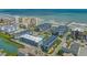 Expansive aerial view of a coastal condominium community featuring multiple buildings, a pool, and ocean access with a pier at 6000 N Ocean Blvd. # 119, North Myrtle Beach, SC 29582