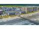 Stunning aerial view of oceanfront condos and a pier; perfect for a coastal vacation getaway at 6000 N Ocean Blvd. # 119, North Myrtle Beach, SC 29582
