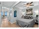 Bright bedroom featuring beachy artwork, a ceiling fan, and access to a serene balcony at 6000 N Ocean Blvd. # 119, North Myrtle Beach, SC 29582