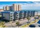 Exterior view of a multi-story condo building with balconies and palm trees, showcasing coastal living at 6000 N Ocean Blvd. # 119, North Myrtle Beach, SC 29582