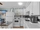 Well-equipped kitchen with white cabinetry, modern appliances, and a breakfast bar overlooking the living area at 6000 N Ocean Blvd. # 119, North Myrtle Beach, SC 29582