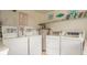 Clean and organized shared laundry room with multiple washers, dryers, and water heater at 6000 N Ocean Blvd. # 119, North Myrtle Beach, SC 29582