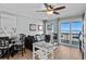 Cozy living room with balcony access showcasing ocean views, comfortable seating, and dining table at 6000 N Ocean Blvd. # 119, North Myrtle Beach, SC 29582