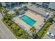 Aerial view of the community pool surrounded by lounge chairs, landscaping, and parking at 6000 N Ocean Blvd. # 119, North Myrtle Beach, SC 29582