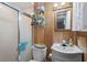 Compact bathroom with shower, toilet, vanity sink and wood paneling at 6001-5742 S Kings Hwy., Myrtle Beach, SC 29575